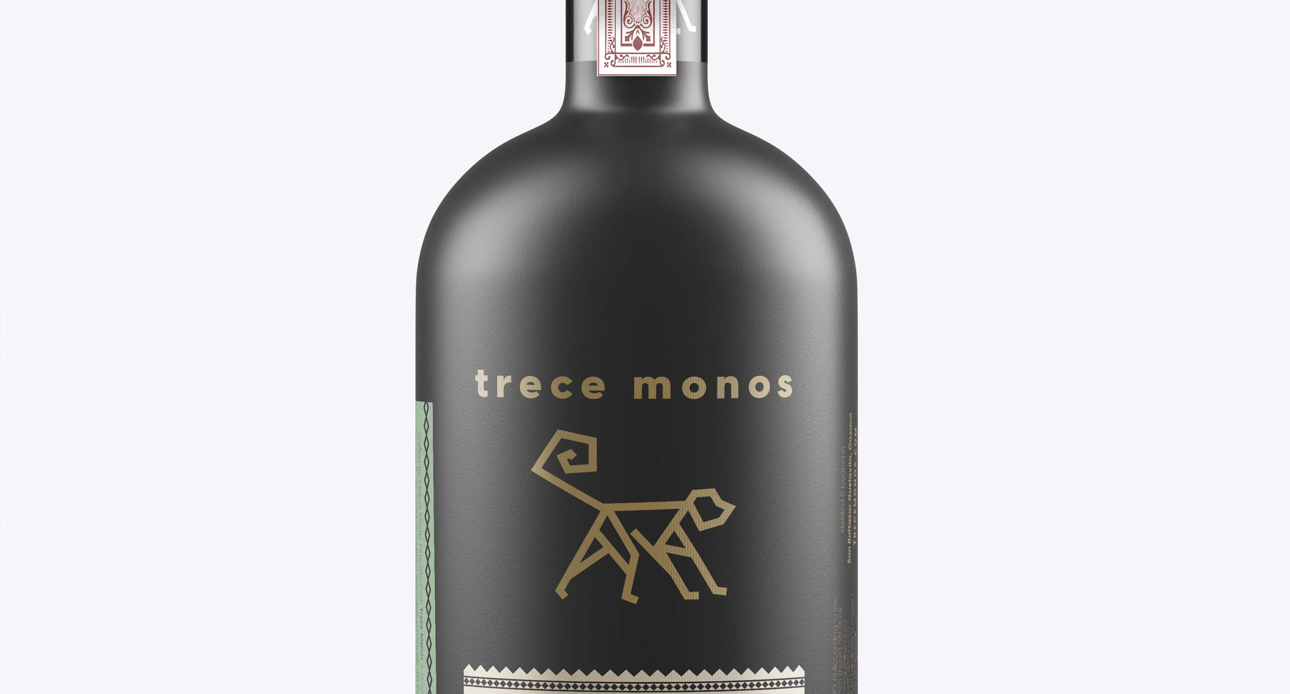 picture of black Trece Monos bottle with gold lettering